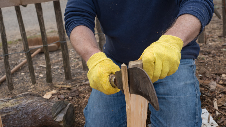 Man cutting wood with billhook