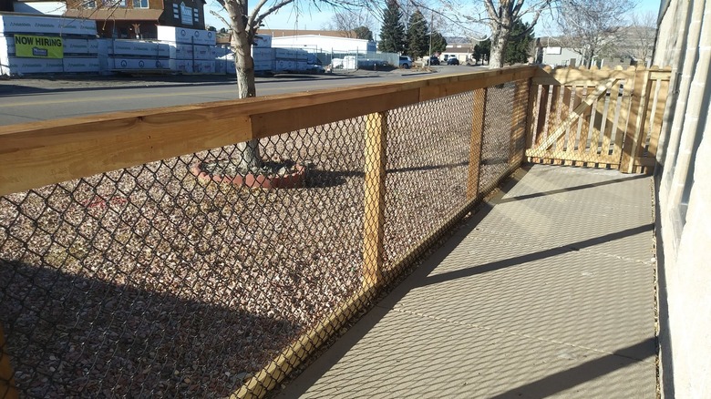 A California-style fence along a walk way near a street