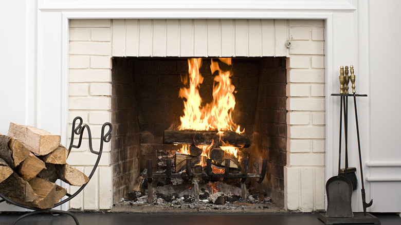 fire in white brick fireplace