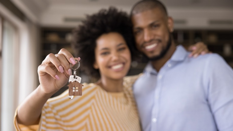 Man and woman holding key