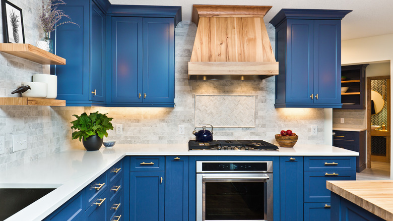 A kitchen with wood range hood