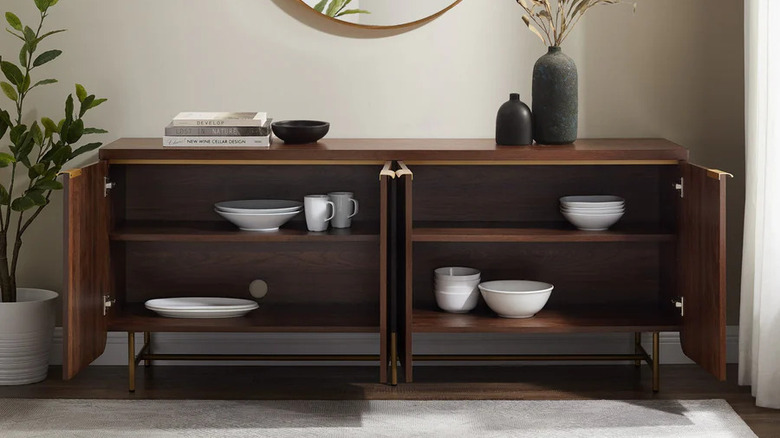 Wooden credenza with dishes stored inside