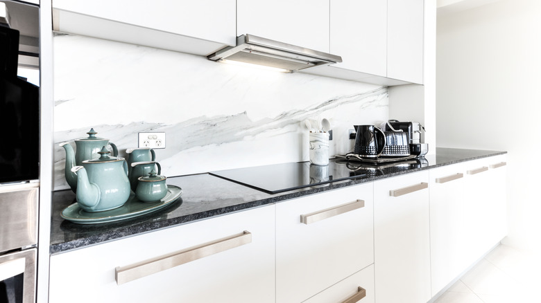 white, chrome, and black galley kitchen