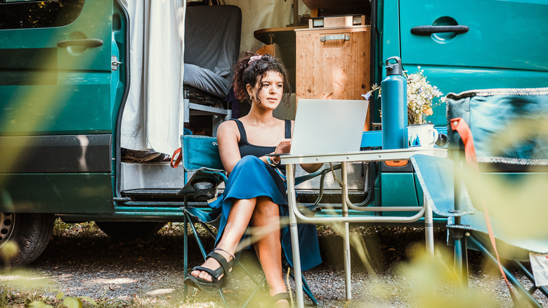 Vanlife woman works on laptop