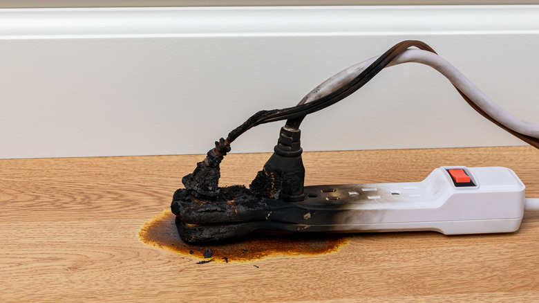 Burned power strip with melted and charred cords