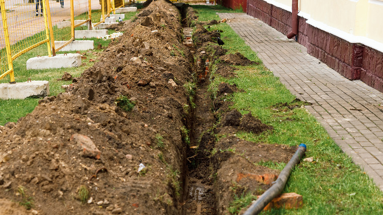 dug ditch for drainage system installation