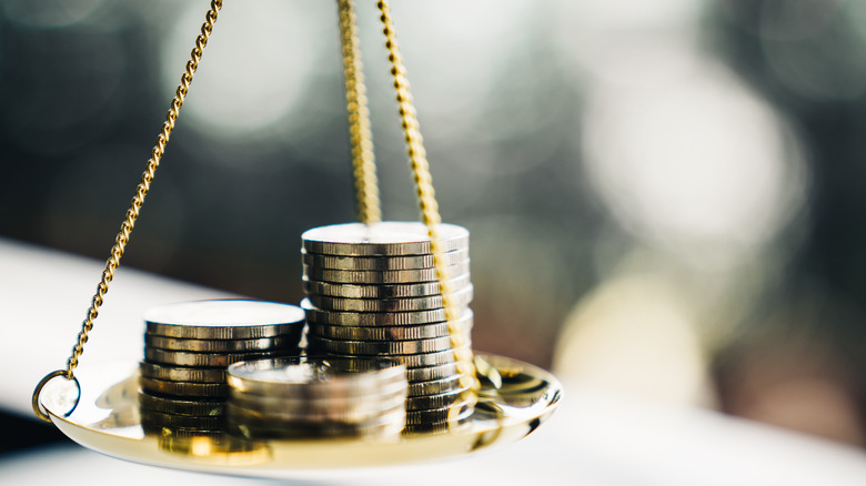 Coins balancing on a scale