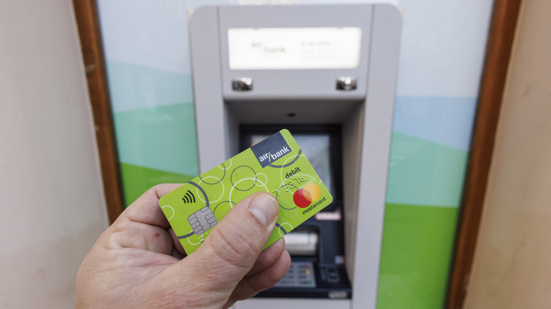 man using card at an ATM