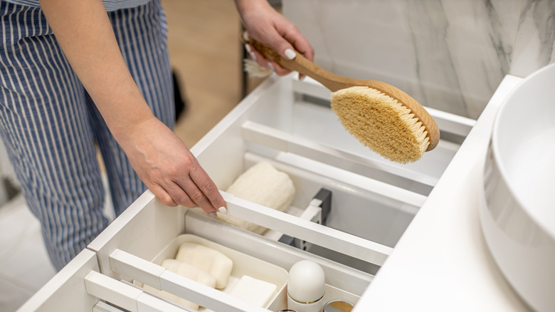 Woman organizing bathroom drawer