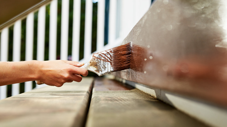 Person painting wooden stair riser