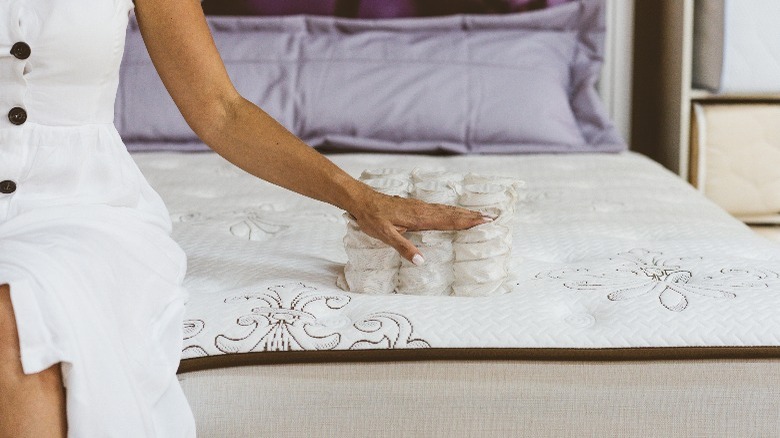 woman sitting on pocket-sprung mattress