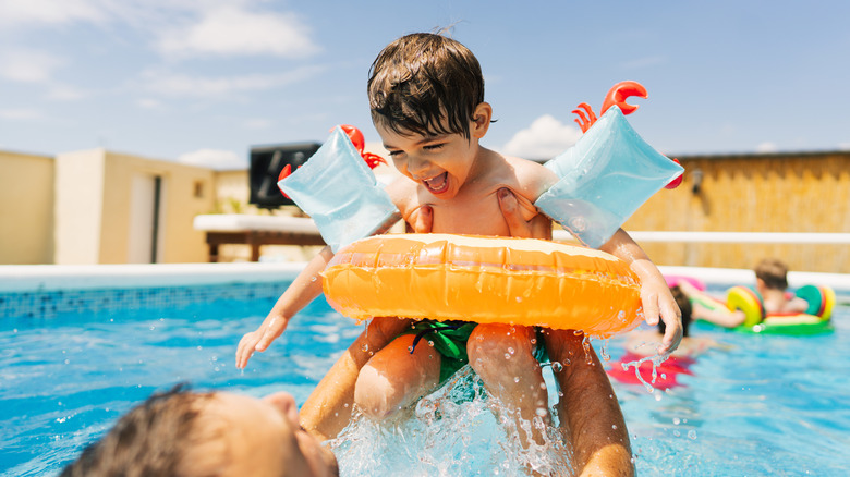 Man and child in swimming pool