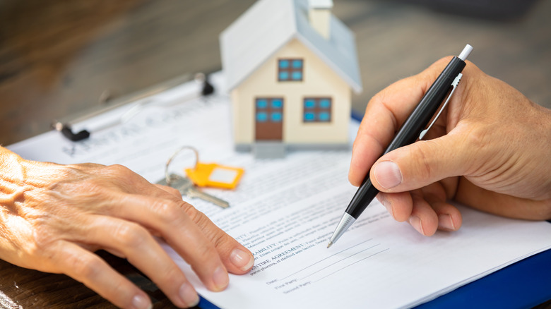 signing documents to buy a home