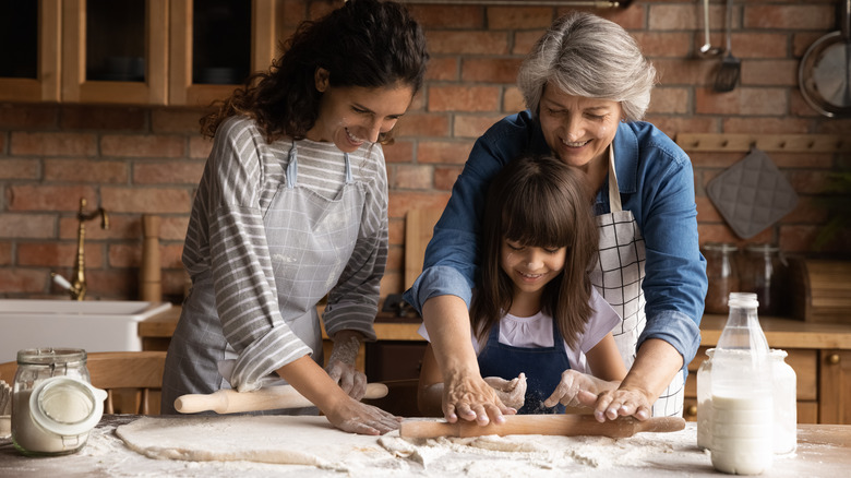 Family rolling out dough