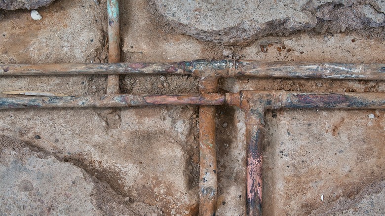 Water pipes encased in an old concrete slab