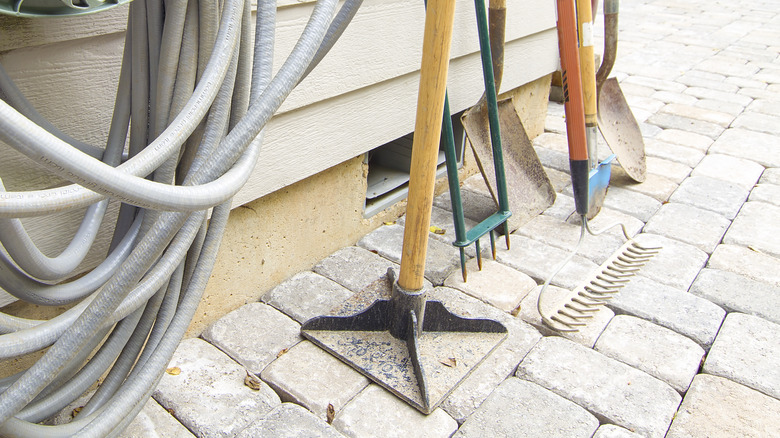 Gardening tools including a hand tamper