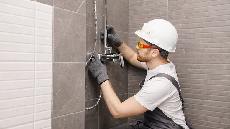 man installing shower 