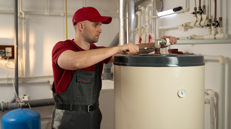 Man fixing water heater tank