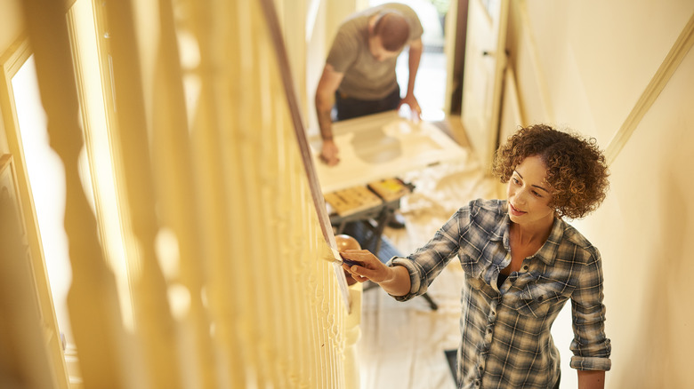 Couple painting banister