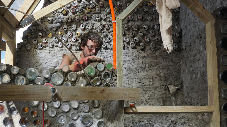 Man building an Earthship