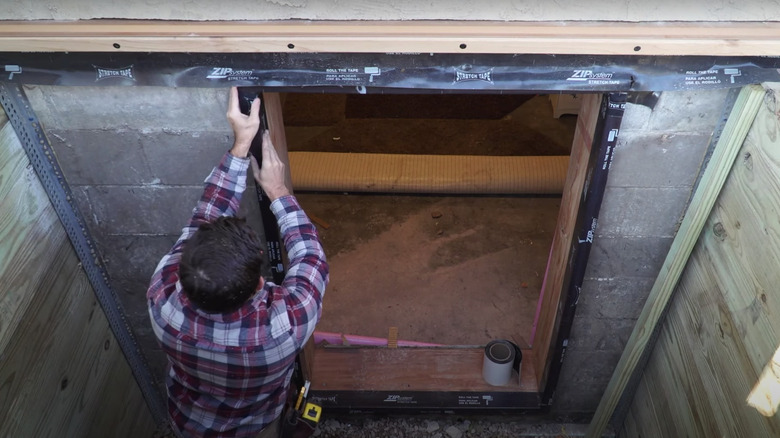 Person installing egress window