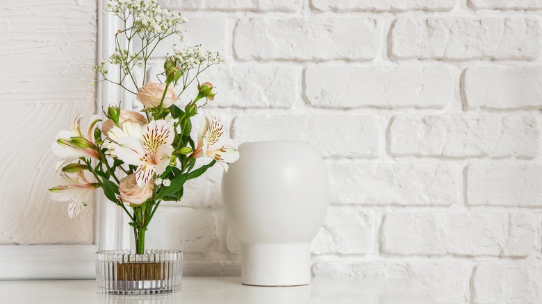 clear ikebana vase on mantel