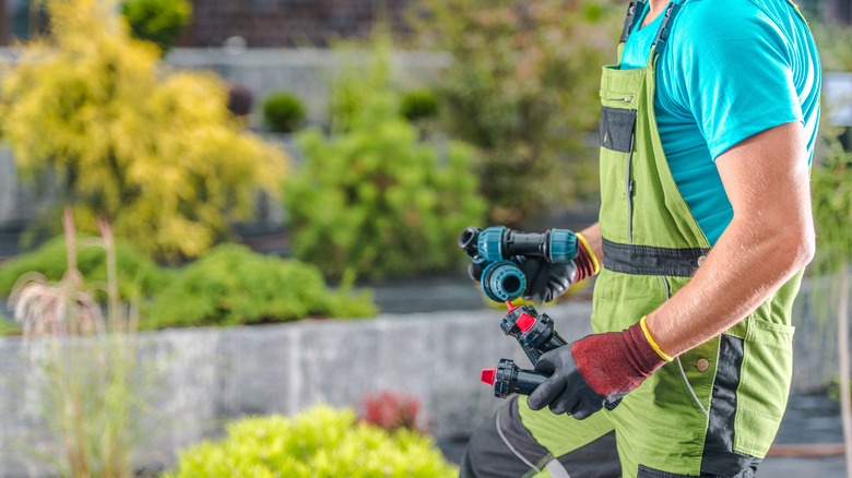 man installing sprinklers 