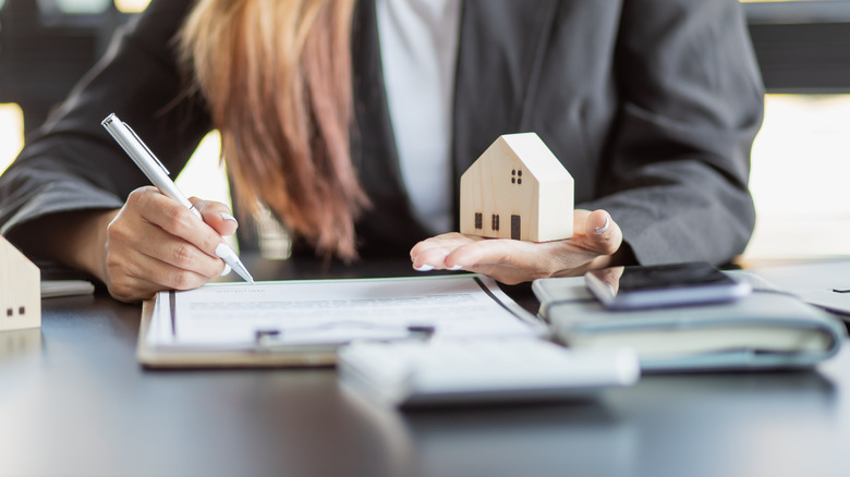 Woman writing loan documents