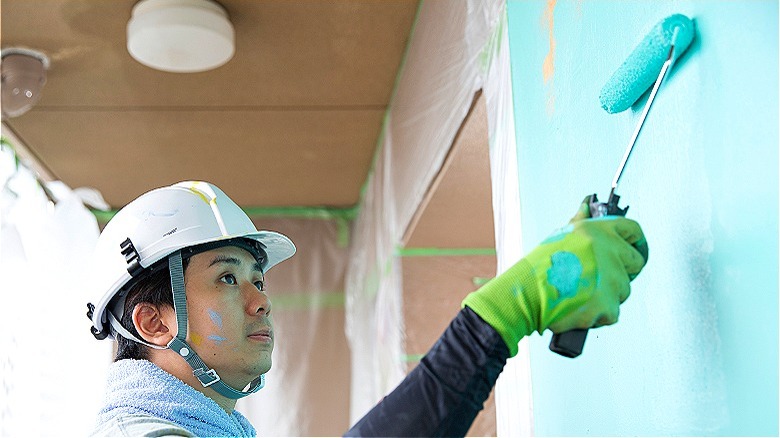 Person using a paint roller