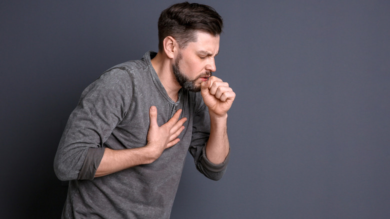 man coughing