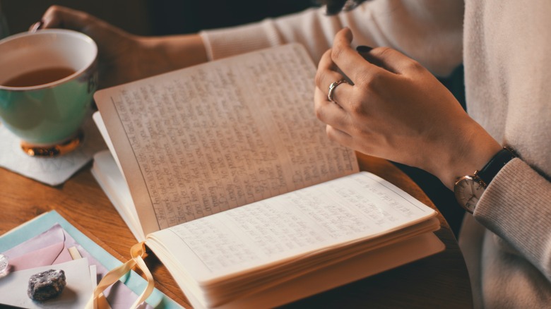 Woman reflecting on journal