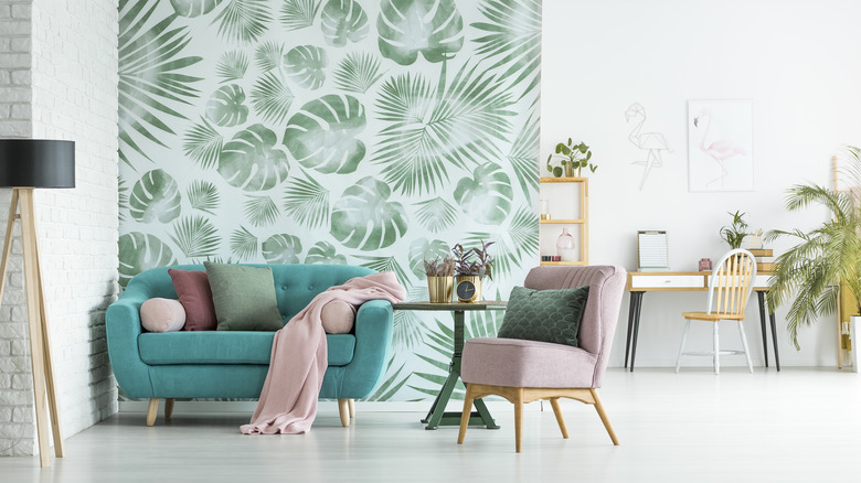 Teal upholstery with leaf wallpaper