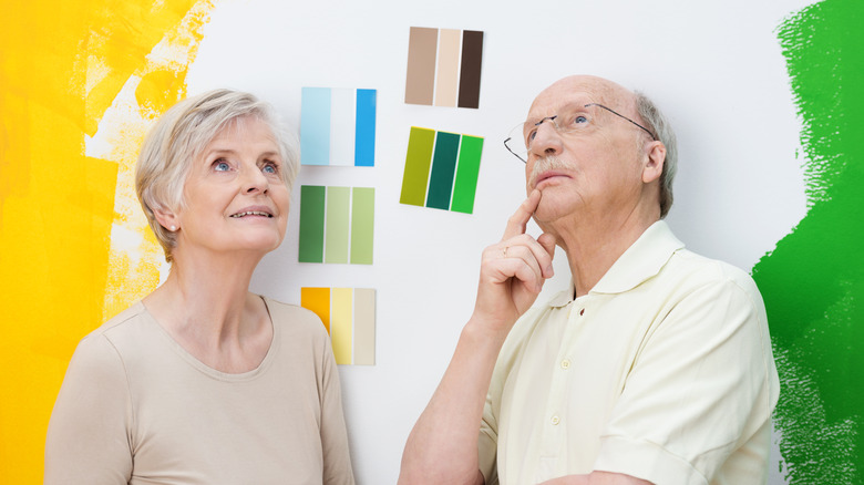 Elderly couple deciding on paint