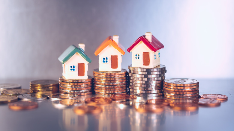 model house and piles of coins