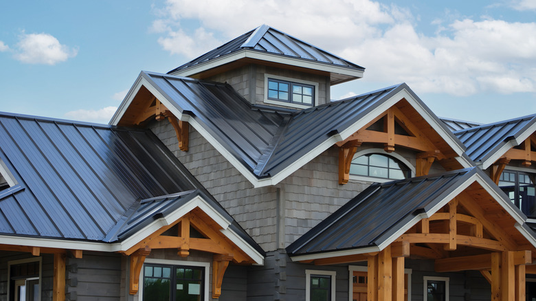 A new home with a complex metal roof and white trim