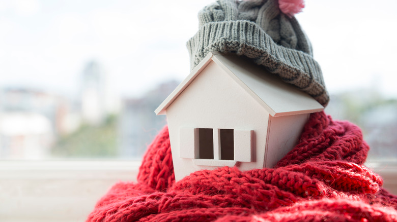 Wooden house with scarf and hat