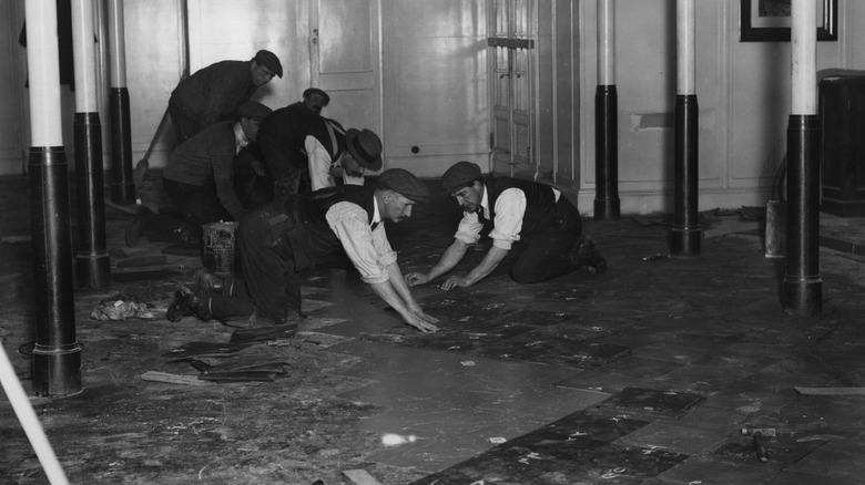 1930s crew installing linoleum floor