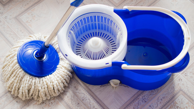 Mop and bucket on linoleum floor