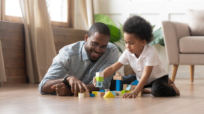 Father and child playing blocks