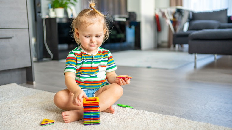 toddler playing with magnetic blocks