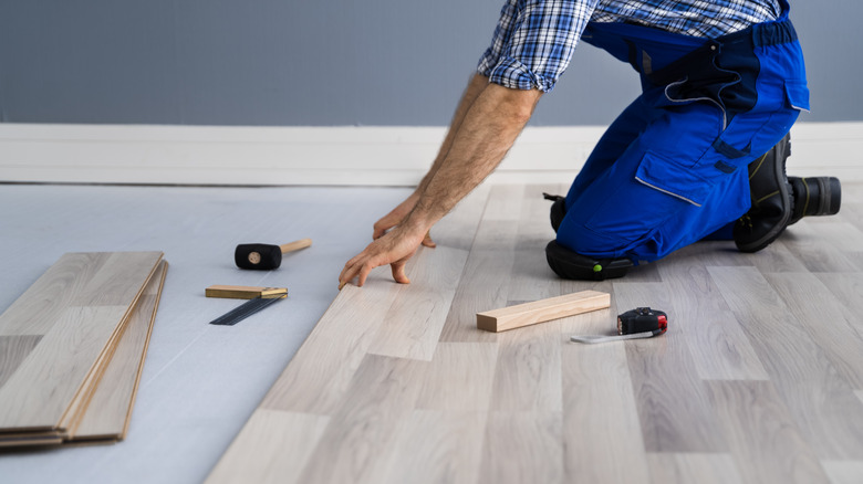 Person installing flooring