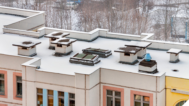 Aerial view of fallen snow on flat roof