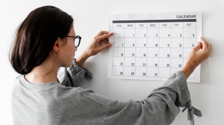Woman looking at calendar page