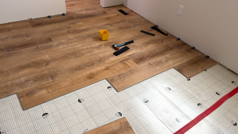 Room with half-finished hardwood floor