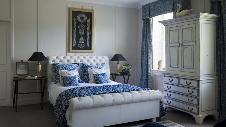 An elegant bedroom is decorated in blue and cream