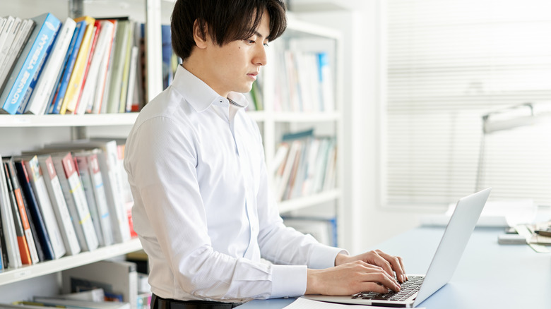 Person typing at standing desk