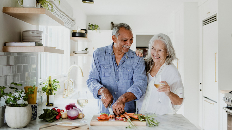 elderly couple cooking together