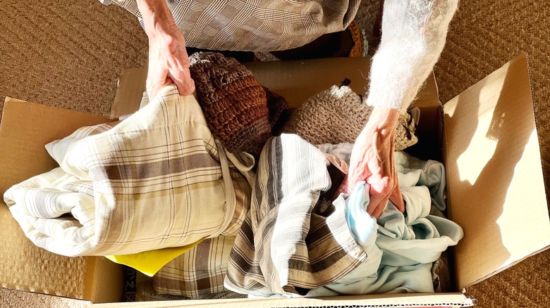 elderly woman packing donations