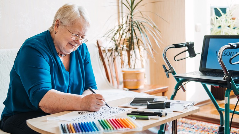 elderly woman practicing calligraphy 