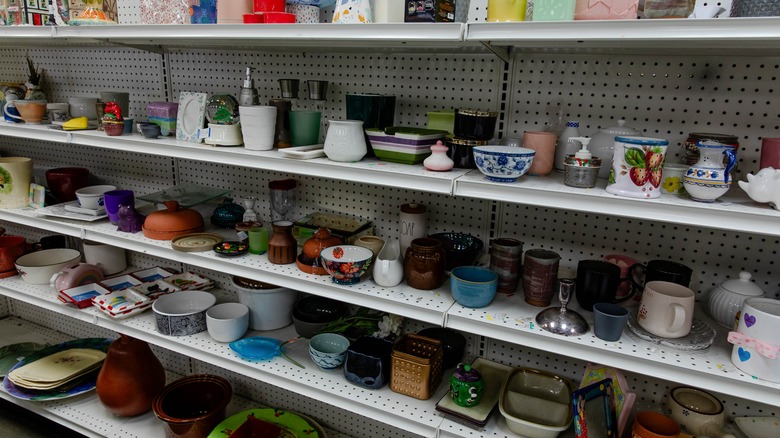 Rows of glassware on thrift store shelves